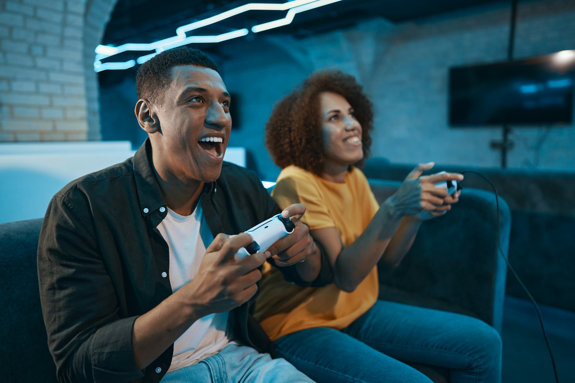 A couple in love is playing a console.